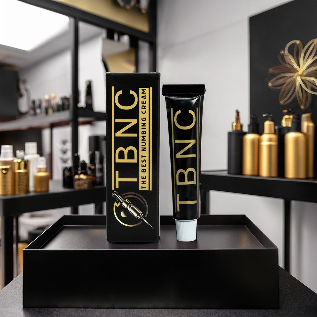TBNC numbing cream packaging on a black tray with a blurred background of shelves with products.