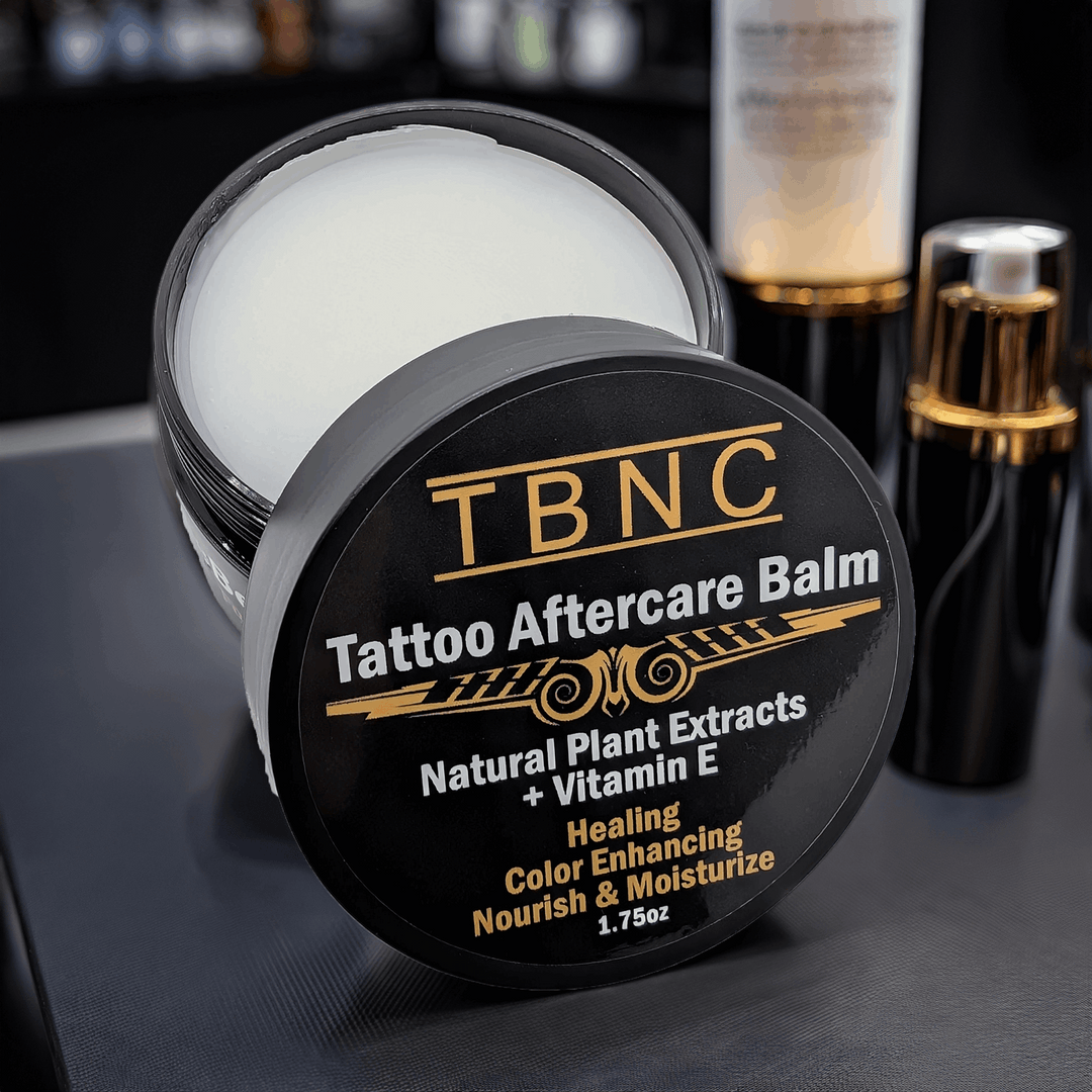 TBNC Tattoo Aftercare Balm container on a dark surface with blurred background
