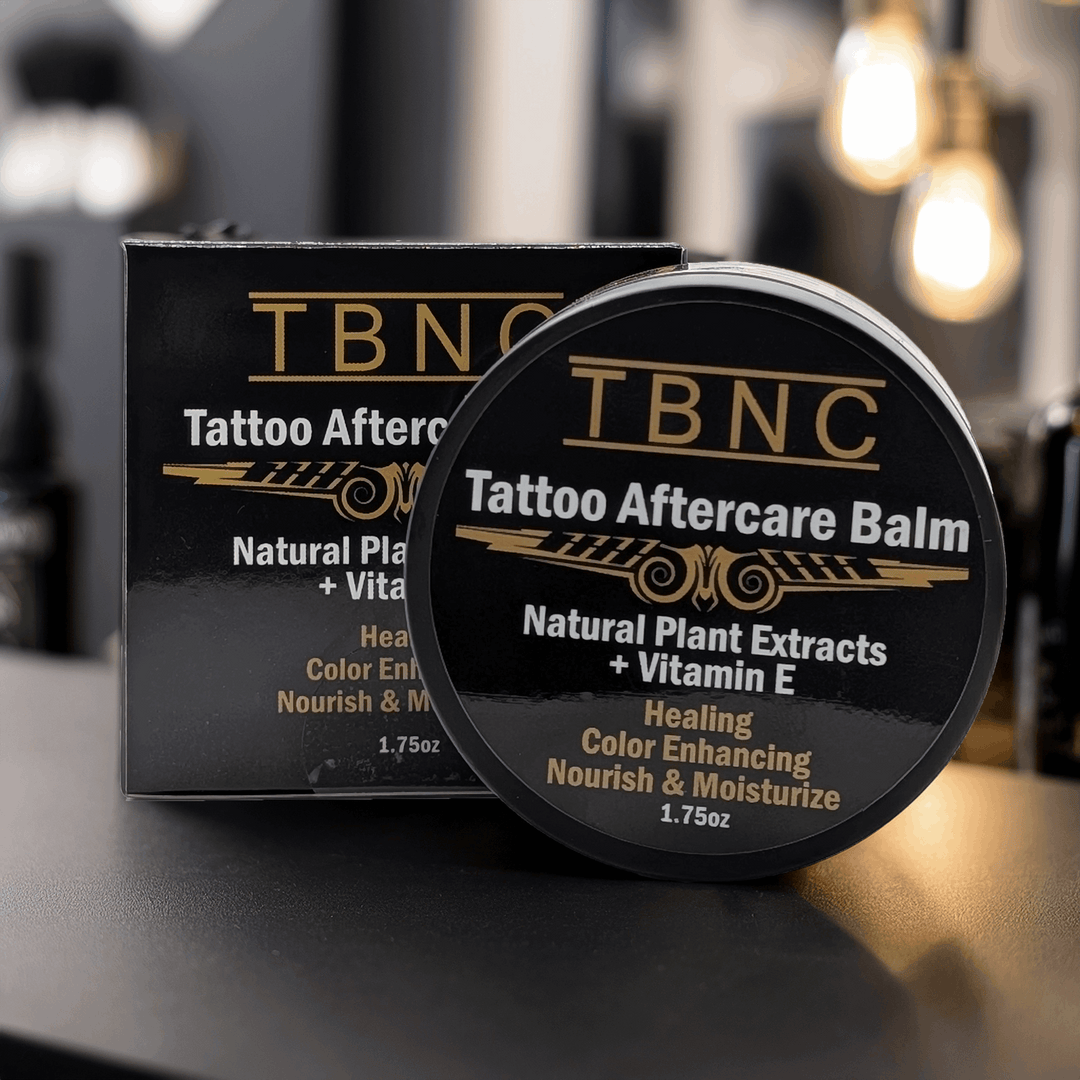 TBNC Tattoo Aftercare Balm packaging on a dark surface with a blurred background