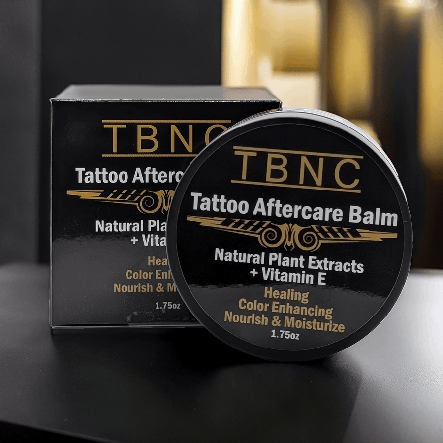 TBNC Tattoo Aftercare Balm container with packaging on a dark surface