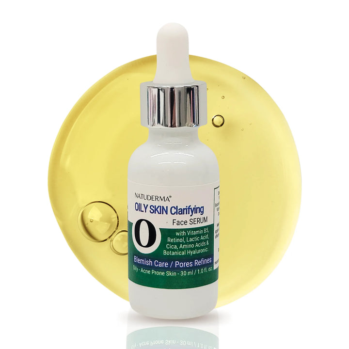 A white 30ml dropper bottle of Natuderma Oily Skin Clarifying Retinol Face Serum centered against a large, translucent yellow drop of the product.