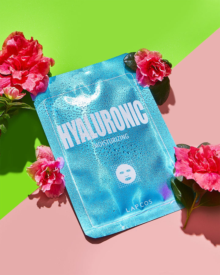 Hyaluronic acid sheet mask with flowers on a colorful background