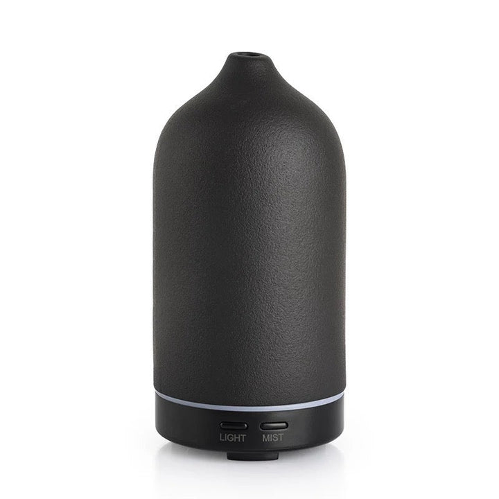 Black essential oil diffuser on a white background
