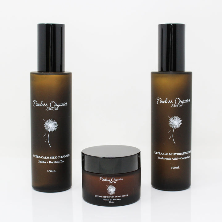 Three bottles of Timeless Organics skincare products on a white background