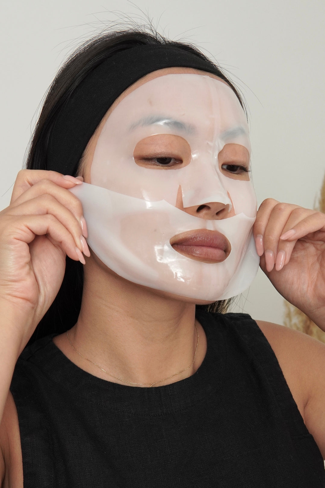 Person wearing a face mask with a neutral background