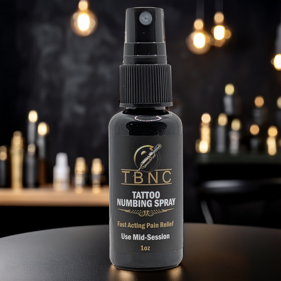 Tattoo numbing spray bottle on dark background. 