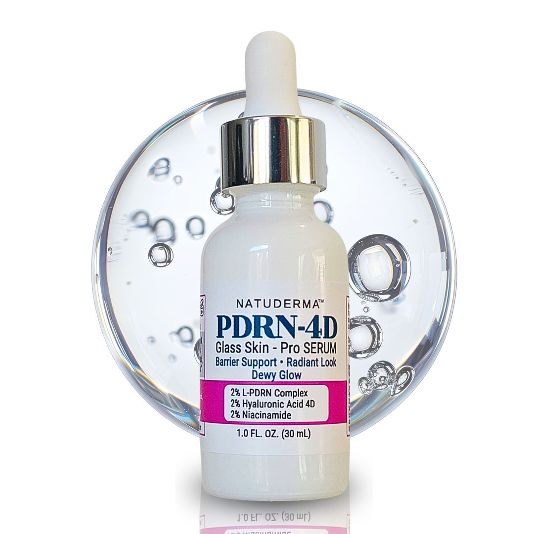 A bottle of Natuderma PDRN-4D Glass Skin Pro Serum, featuring a white dropper cap, silver collar, and a pink and blue label, set against a clear glass bubble background on a white studio background.