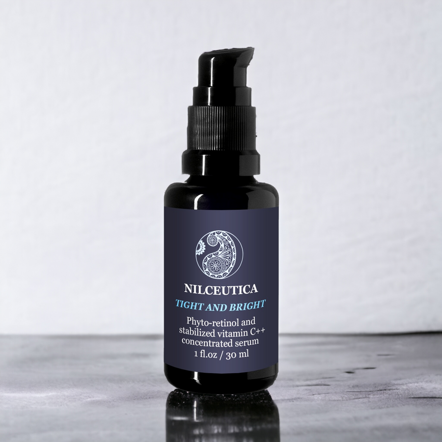 Firming and brightening face serum on black bottle  with gray background 