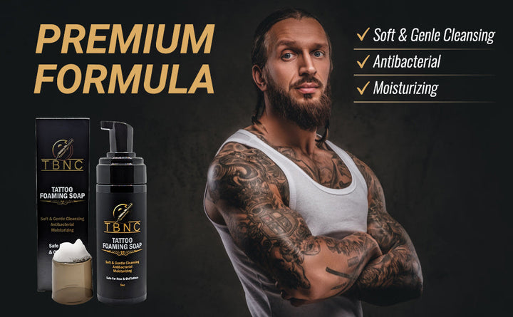 Tattoo and PMU foaming soap on black background with a tattooed men