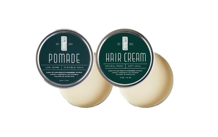 Two hair care products, pomade and hair cream, with green labels on a white background.