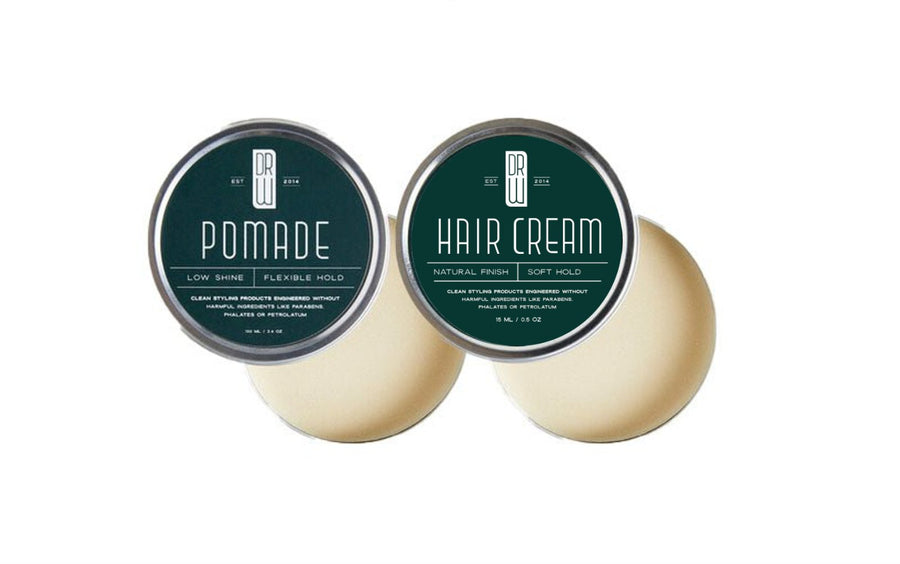 Two hair care products, pomade and hair cream, with green labels on a white background.