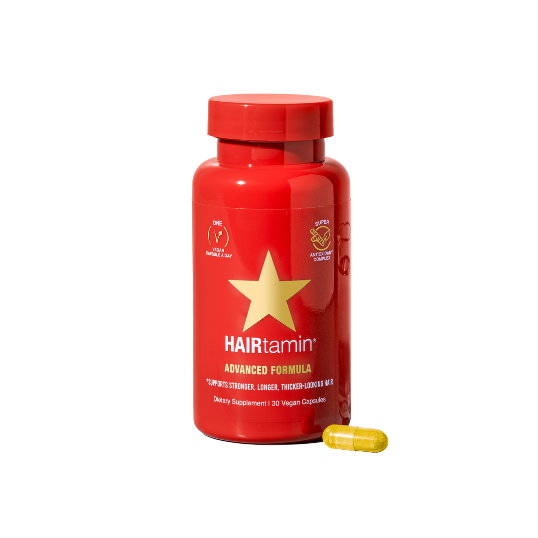 Advance vitamin supplements for stronger and dense hair look , red bottle with a gold star on white background 