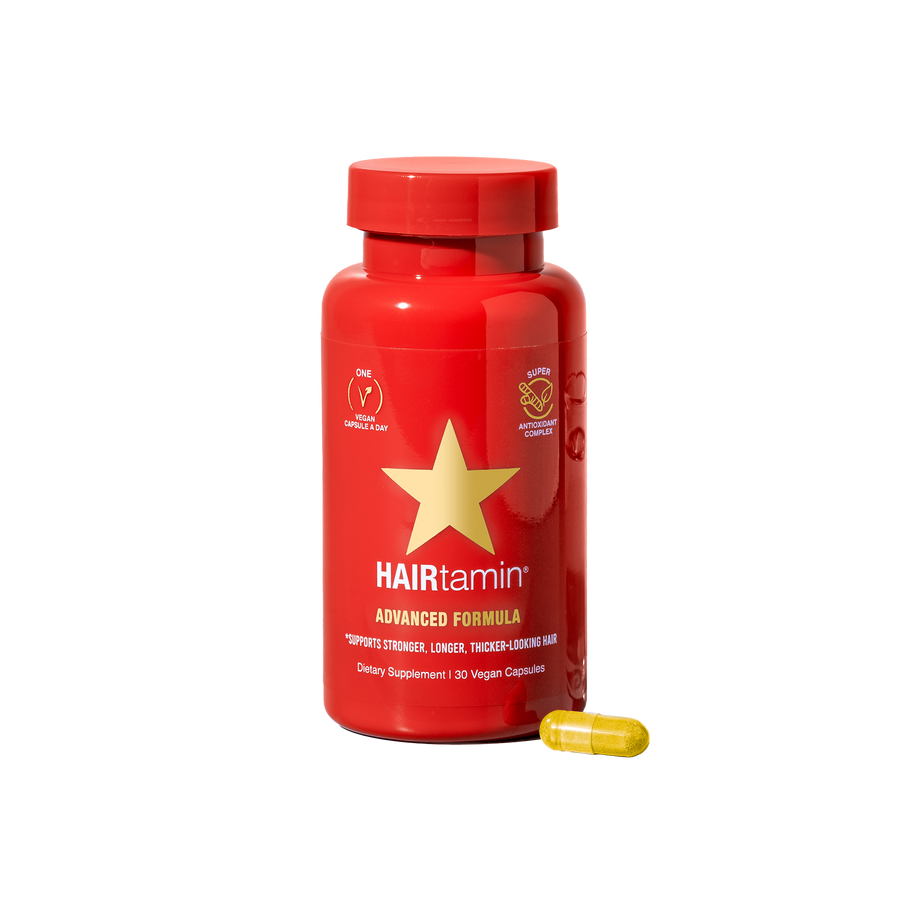 Advance vitamin supplements for stronger and dense hair look , red bottle with a gold star on white background 