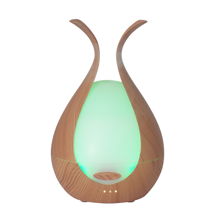 Wooden diffuser with a green light on a white background