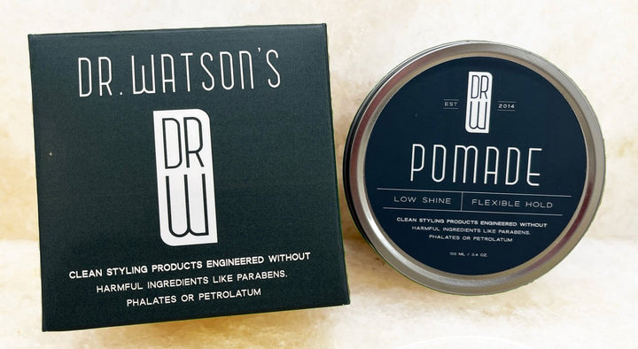 Dr. Watson's pomade container and packaging on a light background