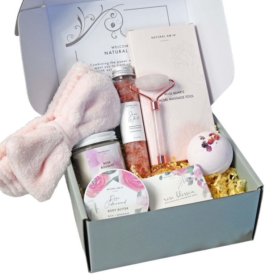Gifting box with self-care items including a bath bomb, body scrub, and towel.